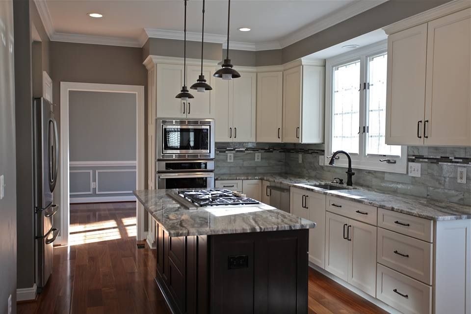 Kitchen - transitional medium tone wood floor kitchen idea in DC Metro with shaker cabinets, white cabinets, granite countertops, glass tile backsplash and an island