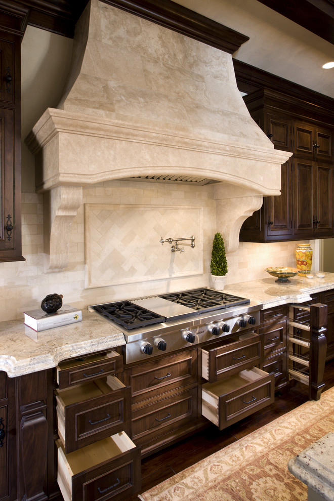 Classic kitchen in Minneapolis with beaded cabinets, dark wood cabinets, granite worktops, beige splashback and stone tiled splashback.