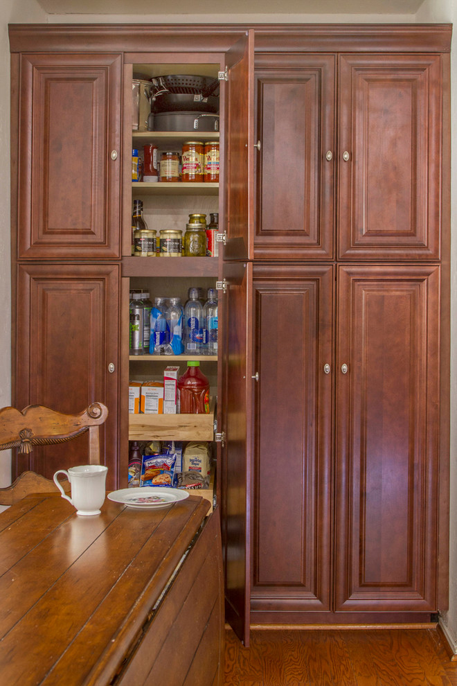 Example of a small classic kitchen pantry design in Dallas with raised-panel cabinets and medium tone wood cabinets
