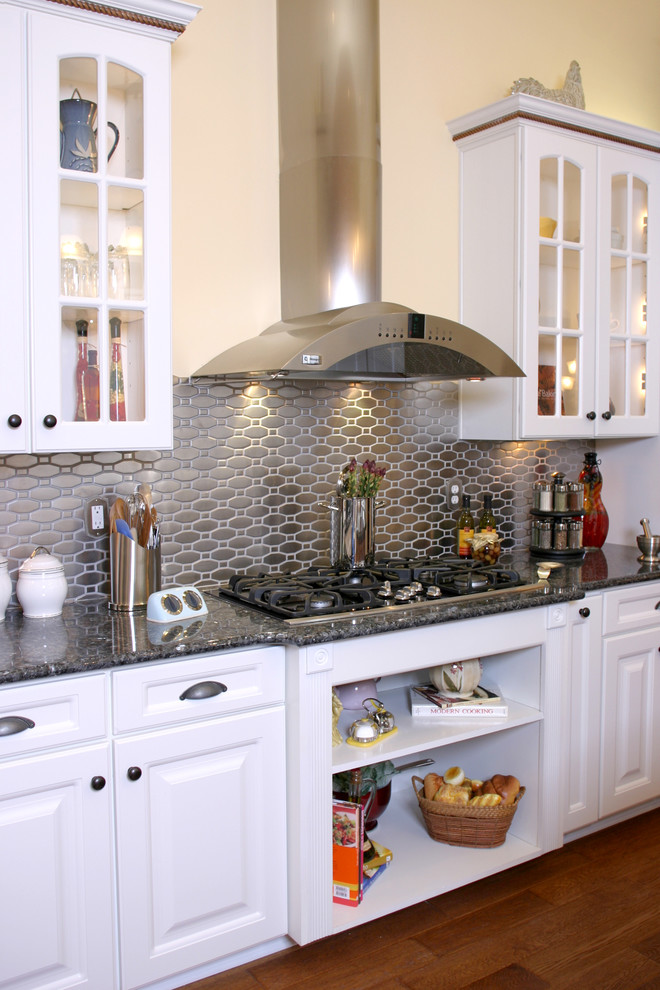Elegant kitchen photo in Jacksonville with granite countertops, metallic backsplash and metal backsplash