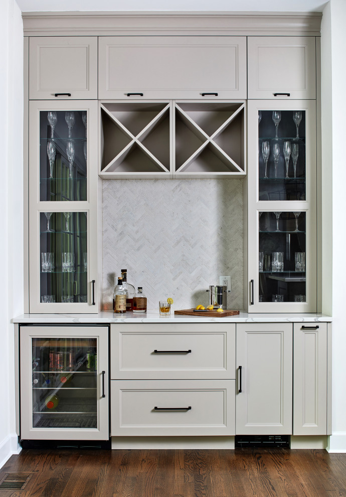Inspiration for a large classic single-wall home bar in DC Metro with beige cabinets, dark hardwood flooring and white worktops.