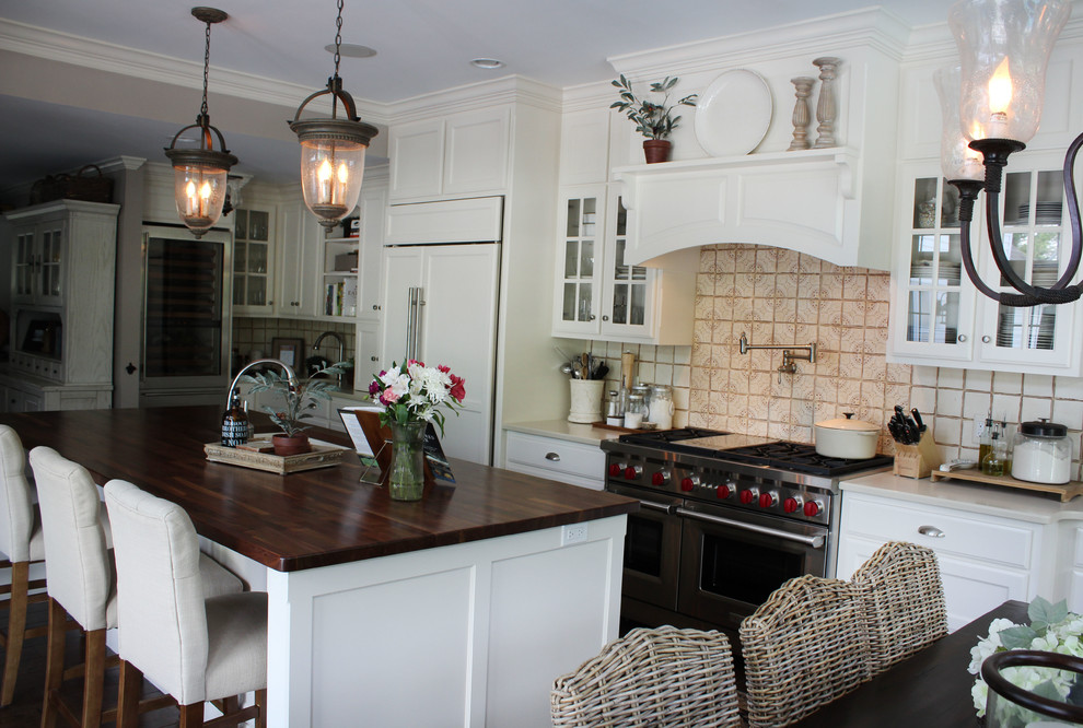 Eat-in kitchen - large traditional single-wall dark wood floor eat-in kitchen idea in Wilmington with shaker cabinets, beige backsplash, an island, a farmhouse sink, white cabinets, wood countertops, ceramic backsplash and white appliances