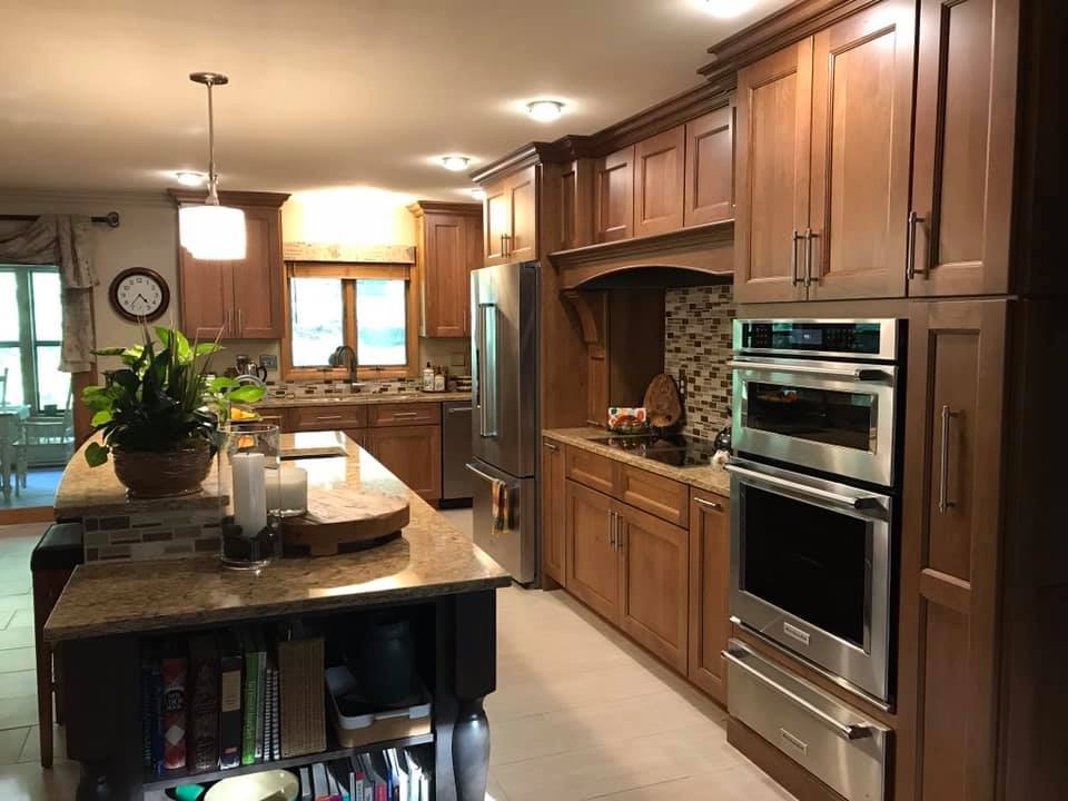 Large eclectic kitchen/diner in Other with a triple-bowl sink, flat-panel cabinets, medium wood cabinets, engineered stone countertops and an island.