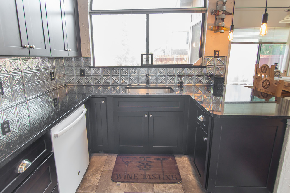 This is an example of a small eclectic l-shaped kitchen/diner in Dallas with a submerged sink, shaker cabinets, brown cabinets, granite worktops, metallic splashback, metal splashback, stainless steel appliances, porcelain flooring, a breakfast bar, beige floors and black worktops.