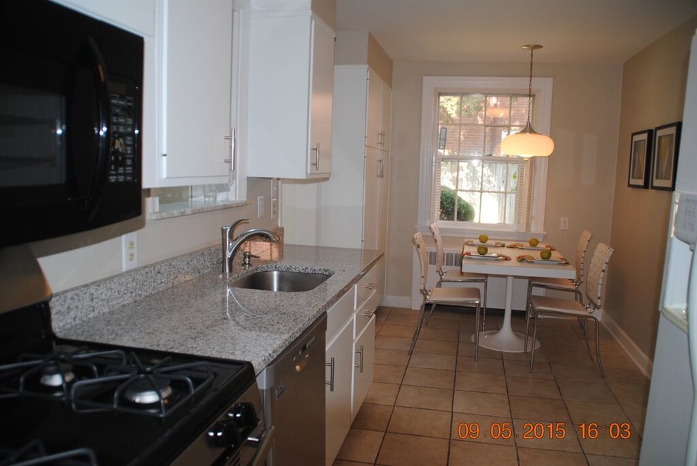 Small classic galley kitchen/diner in Philadelphia with a submerged sink, flat-panel cabinets, white cabinets, laminate countertops, white appliances, ceramic flooring, no island and beige floors.