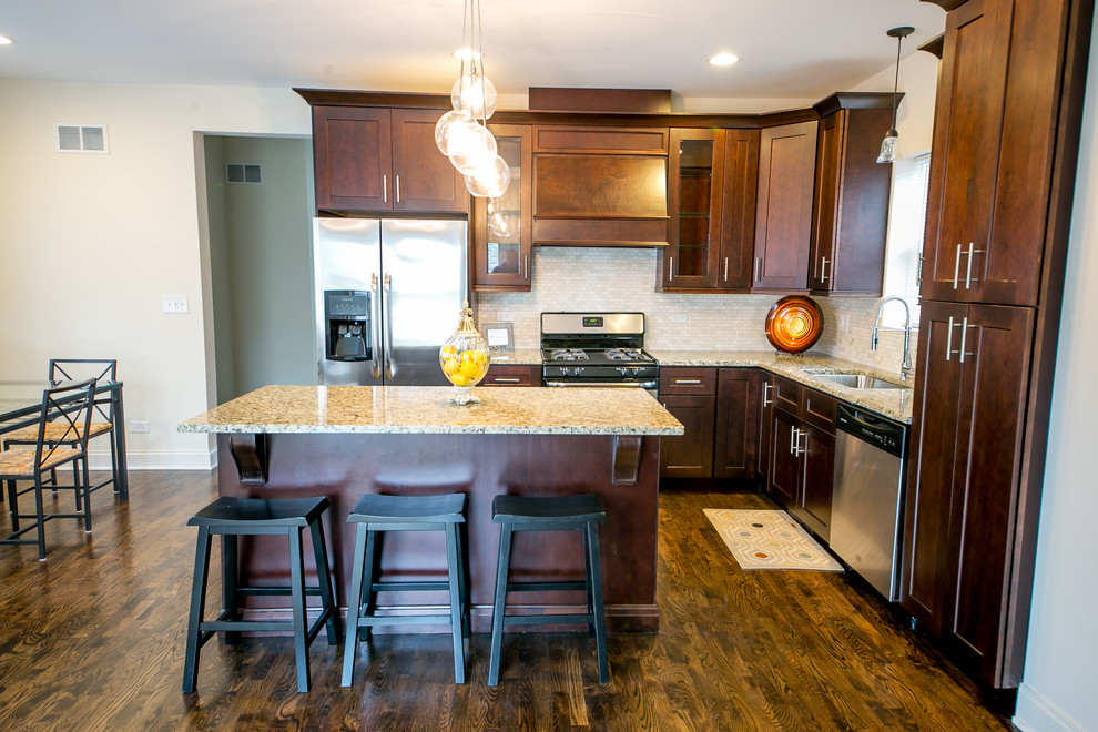 Eat-in kitchen - mid-sized transitional l-shaped dark wood floor and brown floor eat-in kitchen idea in Phoenix with an undermount sink, shaker cabinets, dark wood cabinets, granite countertops, beige backsplash, mosaic tile backsplash, stainless steel appliances and an island