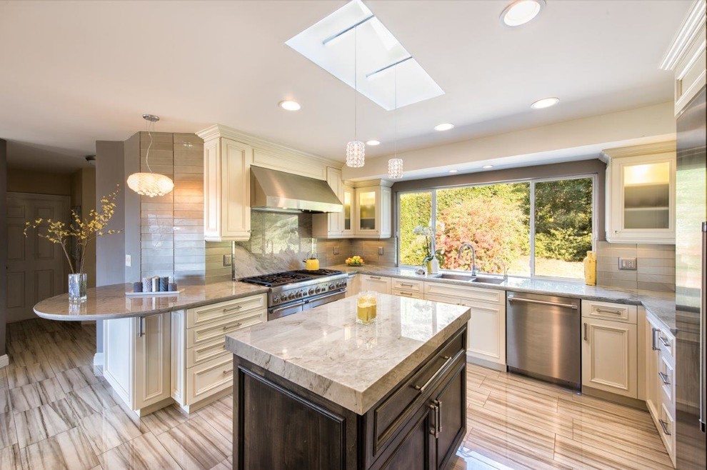 Inspiration for a traditional u-shaped enclosed kitchen in Los Angeles with a double-bowl sink, recessed-panel cabinets, metallic splashback, metal splashback, stainless steel appliances, multiple islands, white cabinets and porcelain flooring.