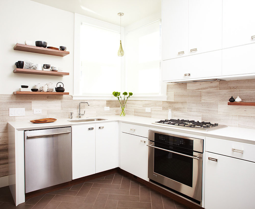 Mid-sized trendy l-shaped ceramic tile enclosed kitchen photo in San Francisco with stainless steel appliances, flat-panel cabinets, white cabinets, quartz countertops, gray backsplash, a single-bowl sink, stone tile backsplash and no island