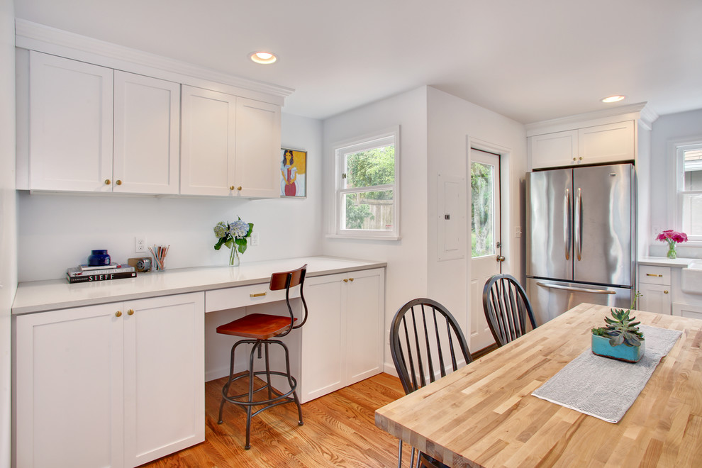 Mid-sized transitional light wood floor eat-in kitchen photo in Seattle with a farmhouse sink, recessed-panel cabinets, white cabinets, quartzite countertops and white backsplash