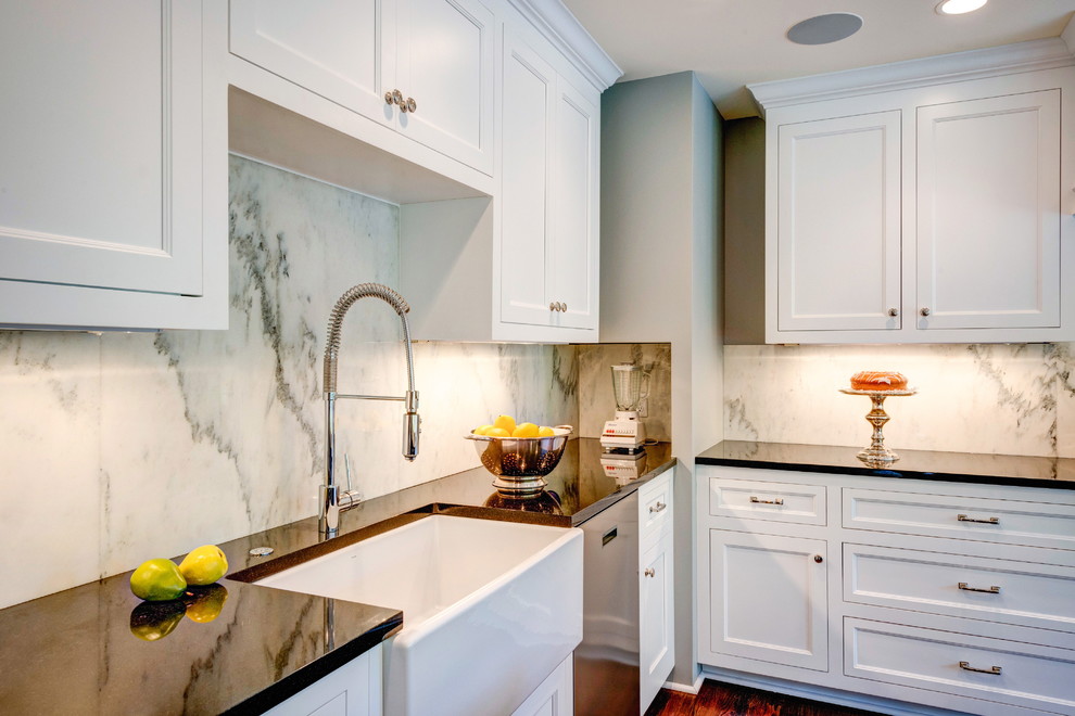 Eat-in kitchen - large traditional l-shaped medium tone wood floor eat-in kitchen idea in DC Metro with a farmhouse sink, flat-panel cabinets, white cabinets, granite countertops, white backsplash, stone slab backsplash, stainless steel appliances and an island