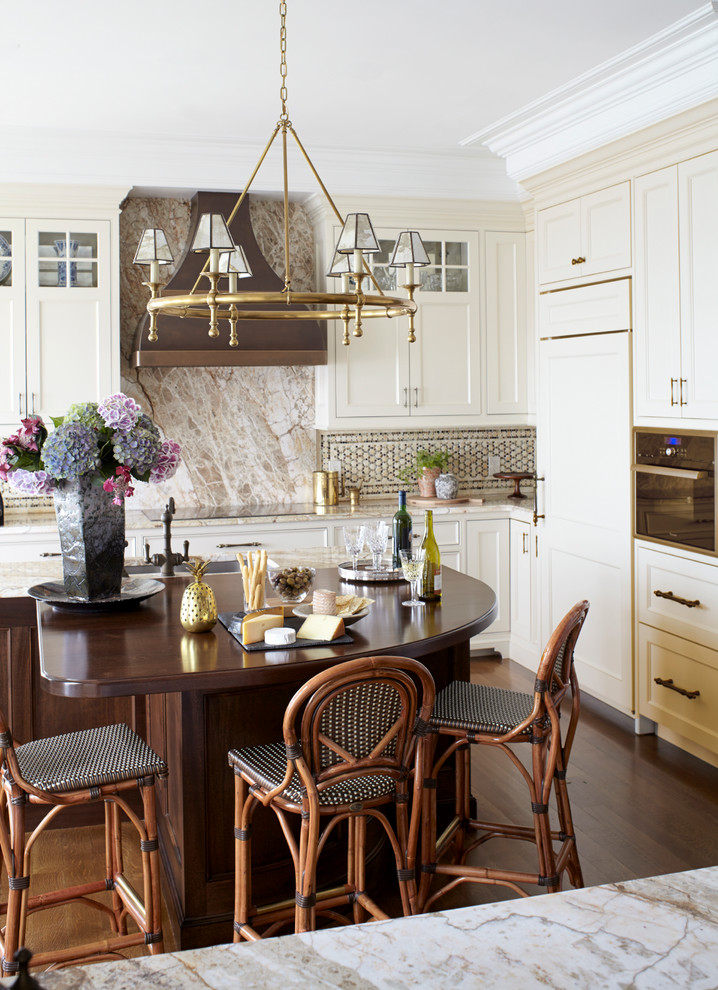 Design ideas for a classic kitchen in New York with shaker cabinets, beige cabinets, marble worktops, beige splashback, integrated appliances, dark hardwood flooring, an island and marble splashback.