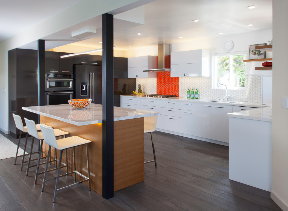 Inspiration for a modern u-shaped dark wood floor and gray floor open concept kitchen remodel in San Diego with a single-bowl sink, flat-panel cabinets, white cabinets, quartz countertops, orange backsplash, ceramic backsplash, black appliances, an island and white countertops