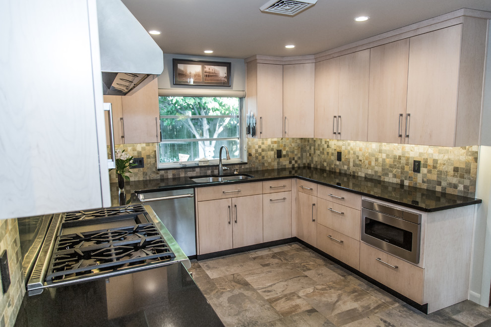 Example of a small trendy u-shaped slate floor and green floor eat-in kitchen design in Other with a double-bowl sink, flat-panel cabinets, light wood cabinets, granite countertops, green backsplash, slate backsplash, stainless steel appliances and no island