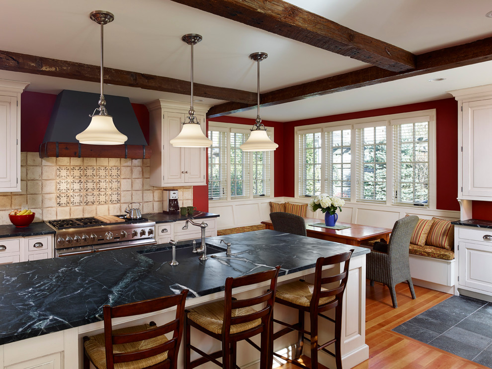 Example of a cottage eat-in kitchen design in Philadelphia with an undermount sink, raised-panel cabinets and soapstone countertops