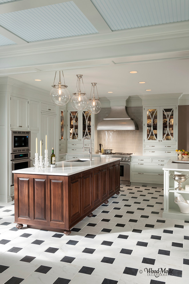 Inspiration for a large timeless u-shaped porcelain tile enclosed kitchen remodel in Houston with a double-bowl sink, recessed-panel cabinets, white cabinets, quartz countertops, white backsplash, stone tile backsplash, stainless steel appliances and an island