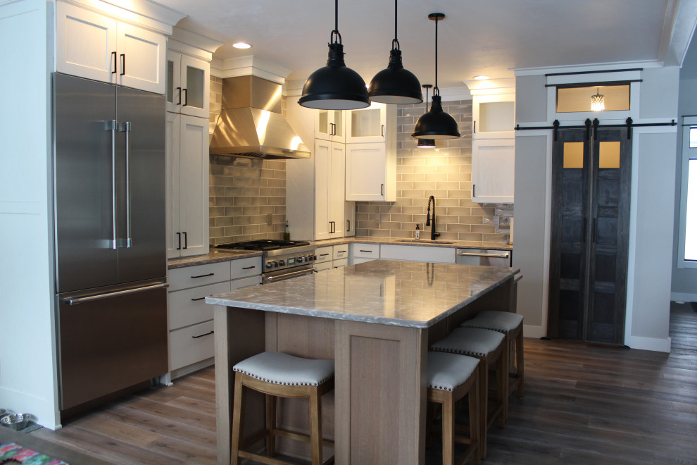 Example of a large transitional l-shaped eat-in kitchen design in Other with recessed-panel cabinets, white cabinets, quartz countertops and an island