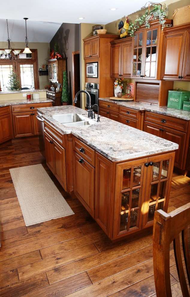 Inspiration for a large classic galley kitchen/diner in Other with a submerged sink, raised-panel cabinets, dark wood cabinets, laminate countertops, yellow splashback, stainless steel appliances, medium hardwood flooring and multiple islands.