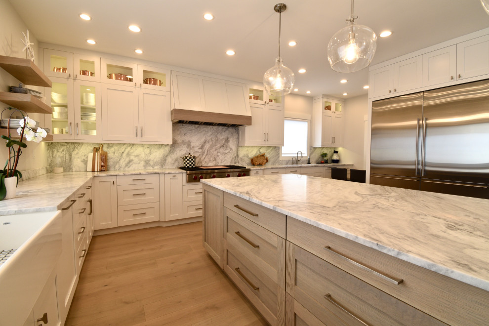 Kitchen - huge coastal kitchen idea in Bridgeport with a farmhouse sink, shaker cabinets, stainless steel appliances and an island