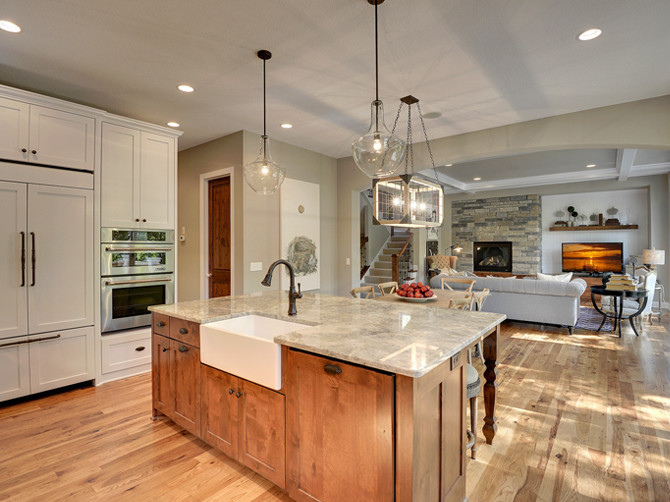 Open concept kitchen - large transitional u-shaped light wood floor open concept kitchen idea in Minneapolis with shaker cabinets, medium tone wood cabinets, marble countertops, an island, gray backsplash, a farmhouse sink, subway tile backsplash and stainless steel appliances