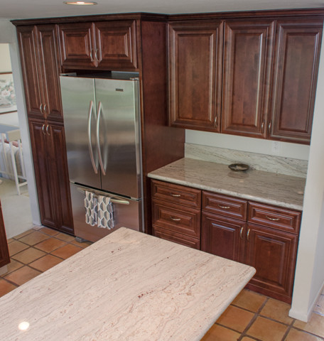 Example of a large classic l-shaped terra-cotta tile open concept kitchen design in Tampa with an undermount sink, raised-panel cabinets, dark wood cabinets, granite countertops, white backsplash, stone slab backsplash, stainless steel appliances and a peninsula