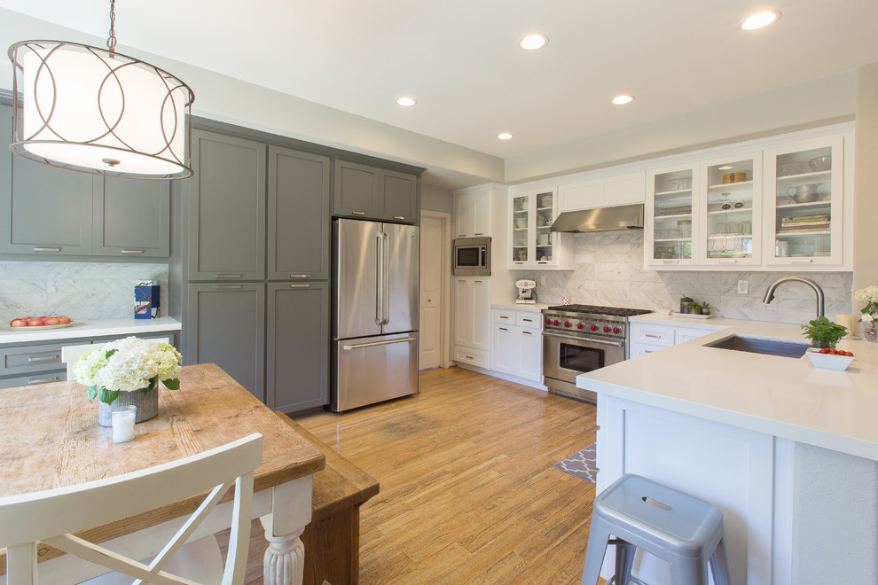 Inspiration for a large kitchen remodel in Sacramento with an undermount sink, shaker cabinets, white cabinets, quartz countertops, white backsplash and stainless steel appliances