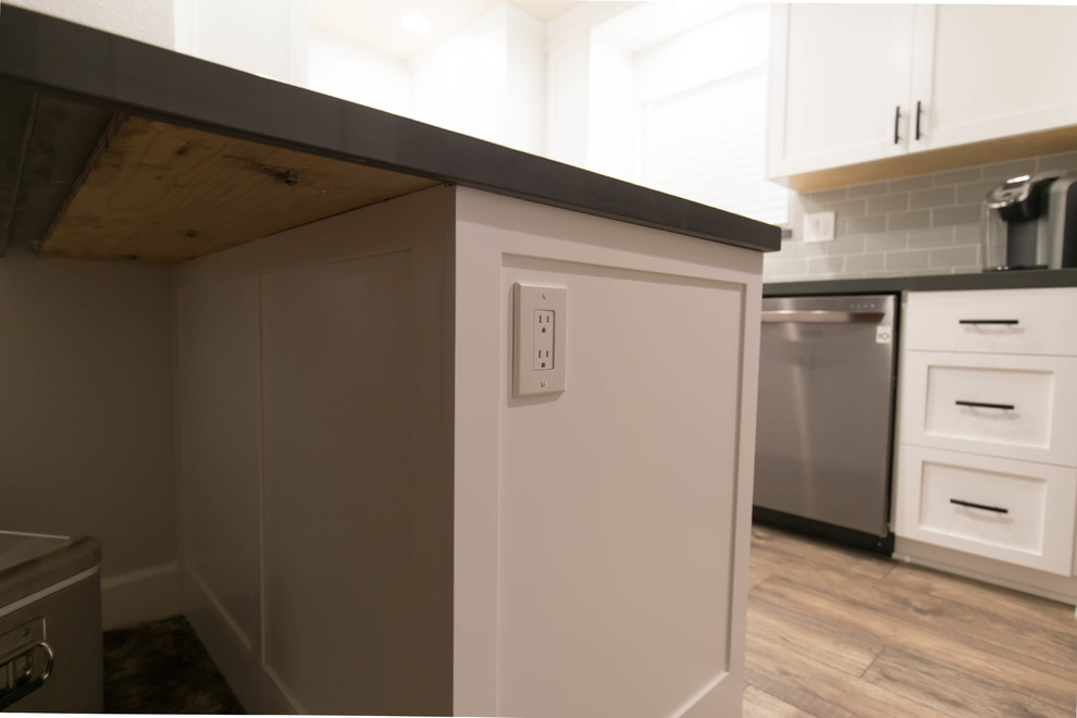 Inspiration pour une cuisine minimaliste avec des portes de placard blanches, un plan de travail en quartz modifié et sol en stratifié.