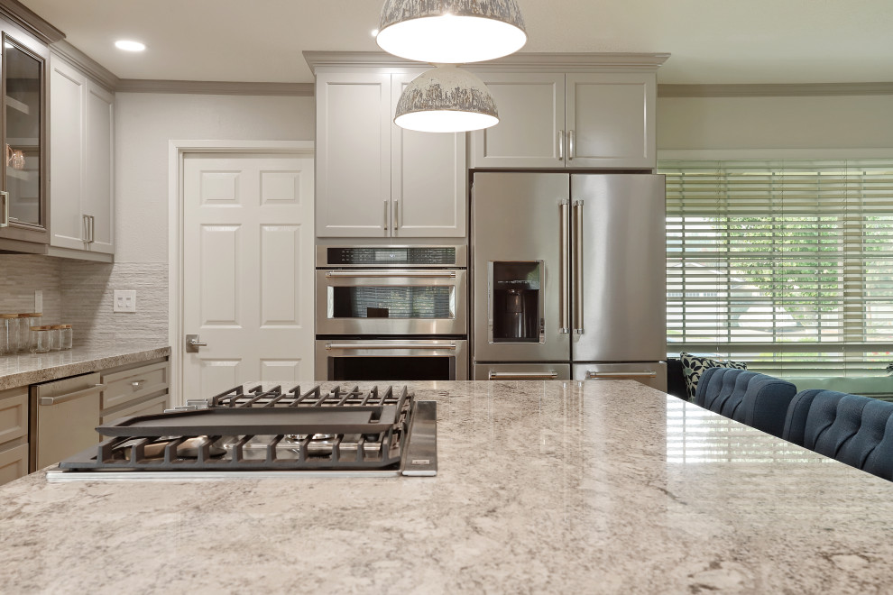 Inspiration for a modern l-shaped eat-in kitchen remodel in Sacramento with an undermount sink, shaker cabinets, gray cabinets, granite countertops, gray backsplash, porcelain backsplash, stainless steel appliances, an island and multicolored countertops