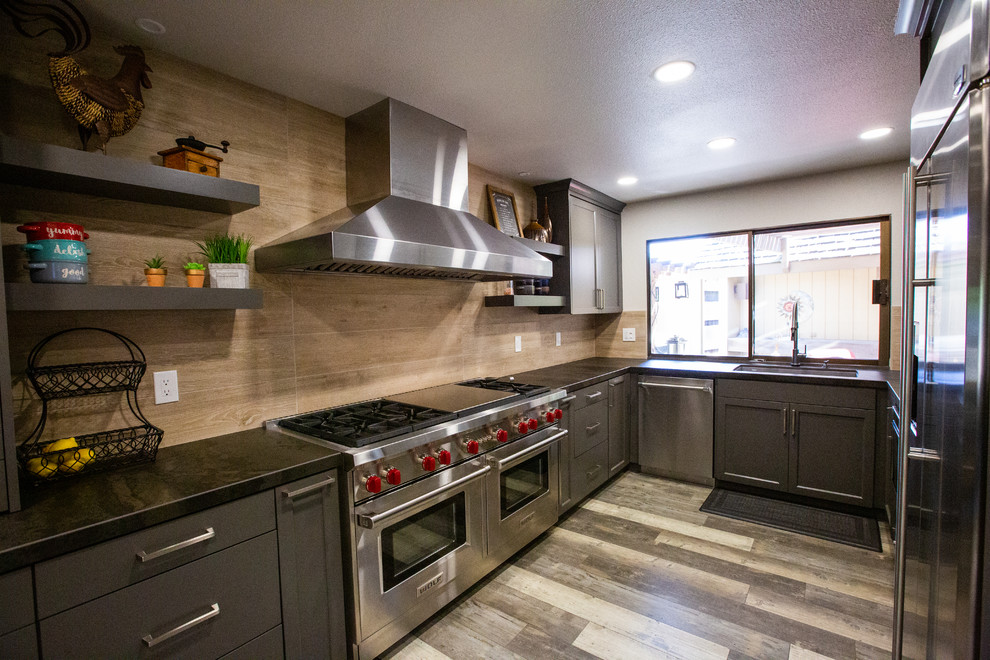 Zweizeilige Moderne Wohnküche ohne Insel mit Unterbauwaschbecken, grauen Schränken, Küchenrückwand in Braun, Küchengeräten aus Edelstahl, braunem Boden und grauer Arbeitsplatte in Sacramento