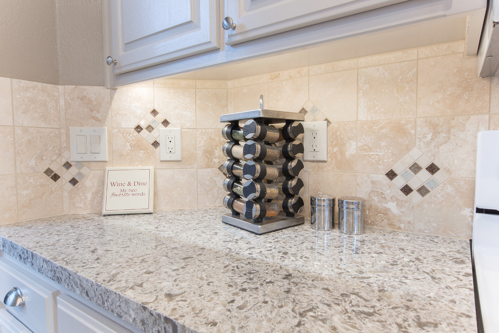 Kitchen - kitchen idea in Sacramento with a double-bowl sink, beige cabinets, quartz countertops, beige backsplash, stone slab backsplash and white appliances