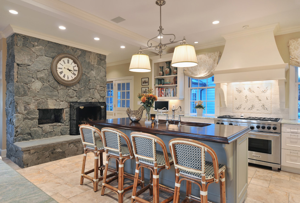 Eat-in kitchen - large traditional l-shaped travertine floor eat-in kitchen idea in New York with recessed-panel cabinets, white cabinets, wood countertops, multicolored backsplash, an undermount sink, ceramic backsplash, stainless steel appliances and an island