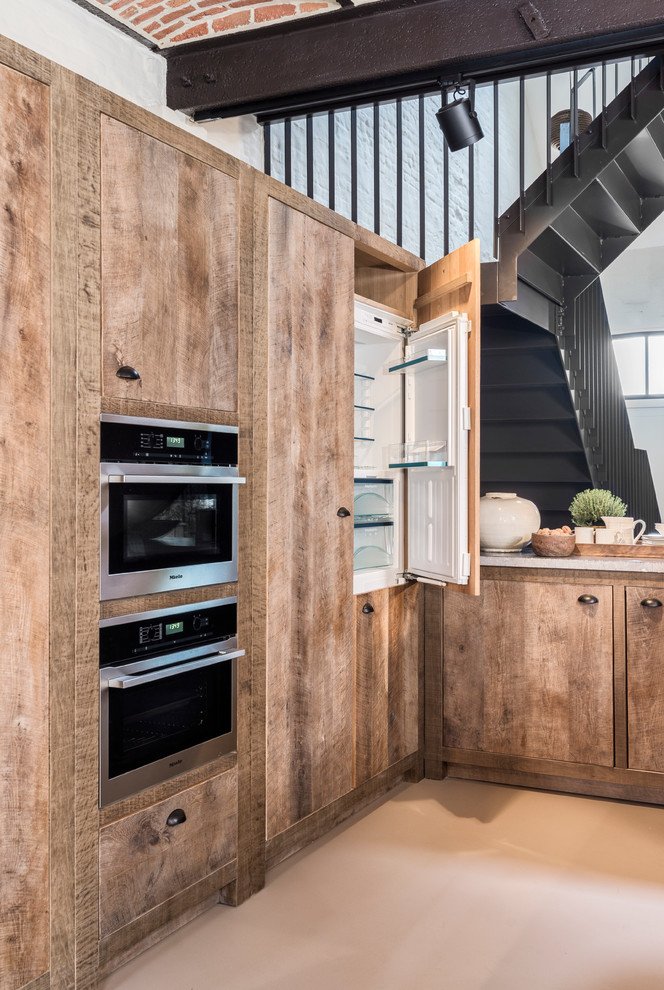 Inspiration for a large country u-shaped open plan kitchen in Other with an integrated sink, medium wood cabinets, black appliances and no island.