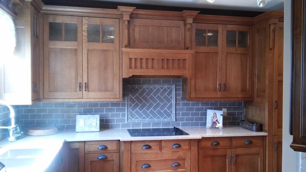 This is an example of a medium sized classic u-shaped kitchen/diner in Columbus with a double-bowl sink, shaker cabinets, medium wood cabinets, granite worktops, grey splashback, stone tiled splashback and stainless steel appliances.