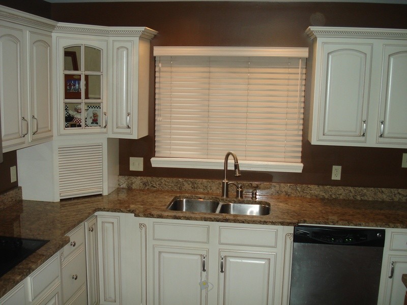 Example of a large classic kitchen design in St Louis with white cabinets, brown backsplash and stainless steel appliances