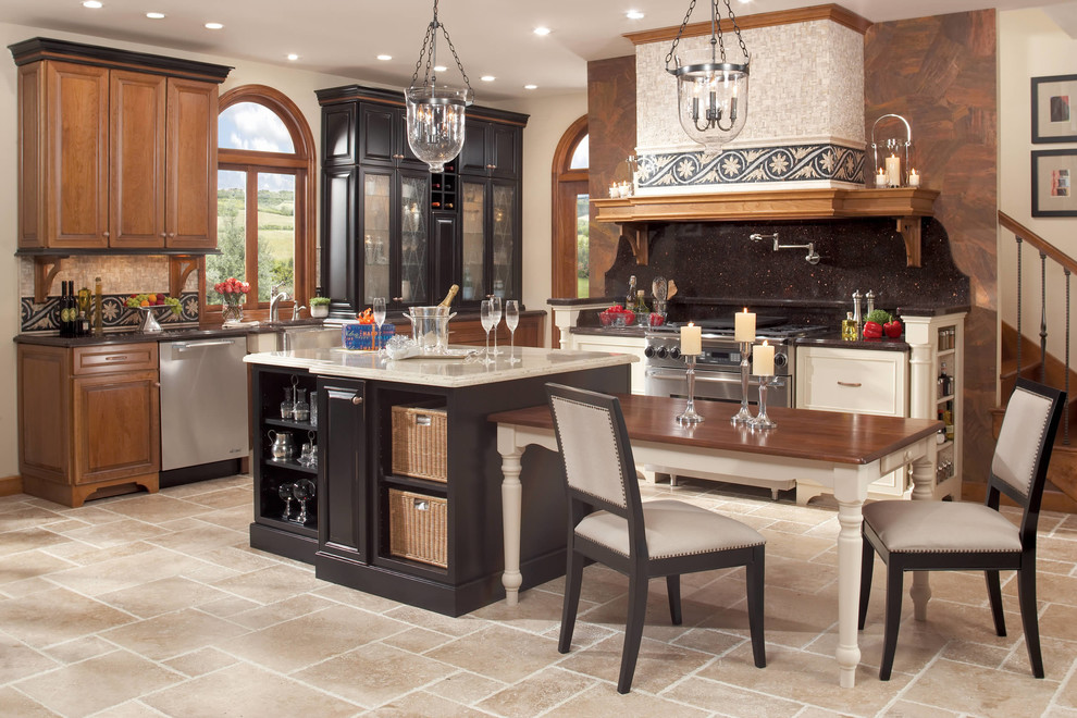 Example of a large transitional single-wall travertine floor and beige floor eat-in kitchen design in Albuquerque with a farmhouse sink, raised-panel cabinets, medium tone wood cabinets, granite countertops, black backsplash, stone slab backsplash, stainless steel appliances and an island