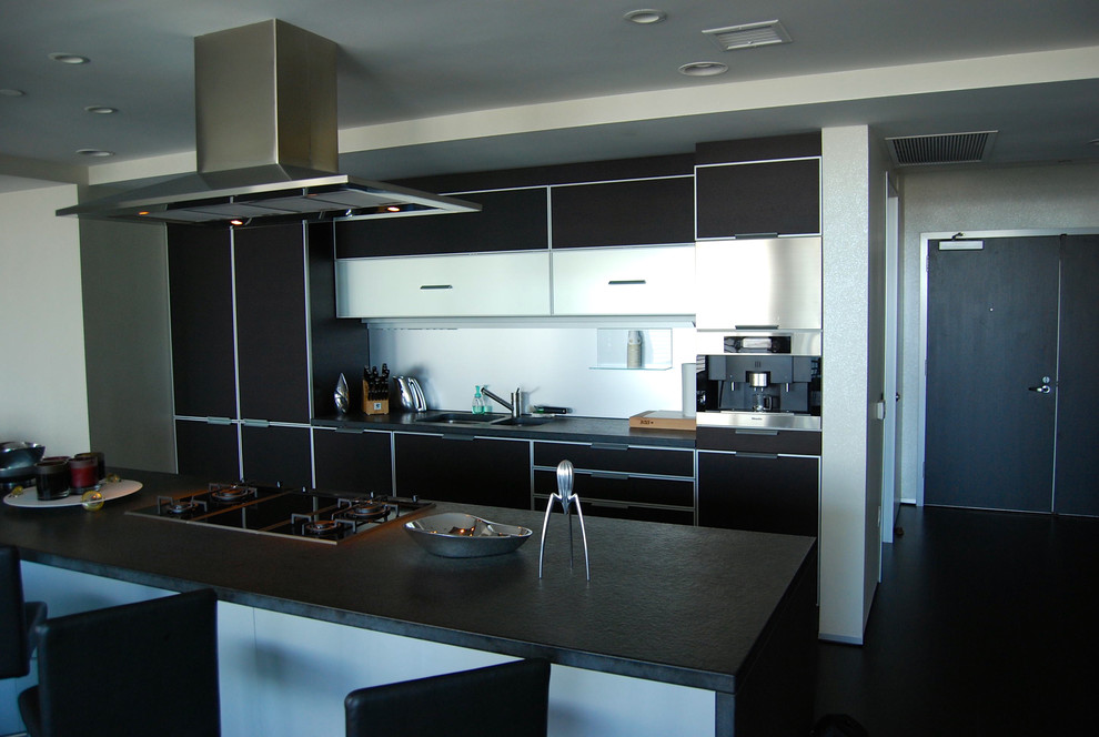 Example of a mid-sized trendy galley dark wood floor open concept kitchen design in Los Angeles with an undermount sink, flat-panel cabinets, quartz countertops, stainless steel appliances and an island