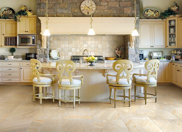 Mid-sized elegant l-shaped light wood floor eat-in kitchen photo in Philadelphia with a drop-in sink, raised-panel cabinets, medium tone wood cabinets, granite countertops, multicolored backsplash, stone tile backsplash, stainless steel appliances and an island
