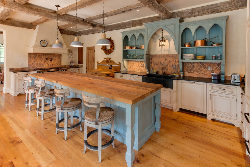 Kitchen - traditional u-shaped kitchen idea in Other with a farmhouse sink, open cabinets, blue cabinets and brown backsplash