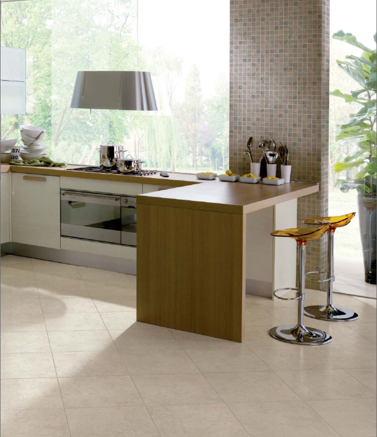 Example of a mid-sized trendy l-shaped ceramic tile eat-in kitchen design in San Francisco with flat-panel cabinets, white cabinets, wood countertops, brown backsplash, mosaic tile backsplash, stainless steel appliances and a peninsula