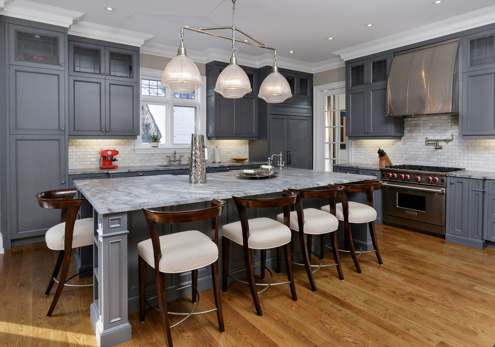 Eat-in kitchen - large traditional l-shaped light wood floor eat-in kitchen idea in Toronto with gray cabinets, marble countertops, white backsplash, subway tile backsplash, stainless steel appliances, an island and beaded inset cabinets