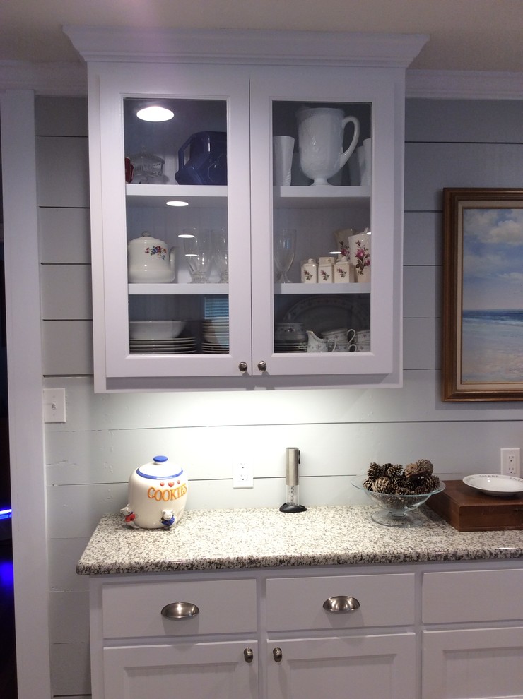 Inspiration for a nautical kitchen in Austin with white cabinets, granite worktops, multi-coloured splashback and an island.