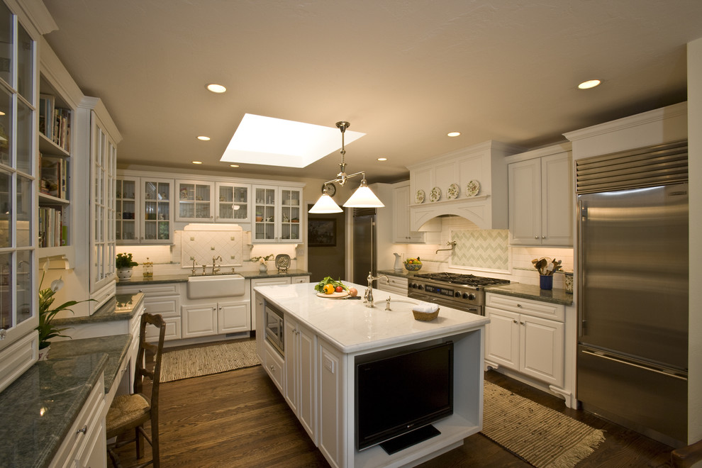 Inspiration for a timeless l-shaped enclosed kitchen remodel in San Francisco with glass-front cabinets, stainless steel appliances, a farmhouse sink, white cabinets and multicolored backsplash