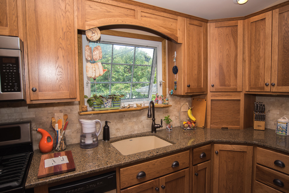 Mid-sized elegant l-shaped ceramic tile enclosed kitchen photo in New York with a drop-in sink, recessed-panel cabinets, medium tone wood cabinets, quartz countertops, beige backsplash, porcelain backsplash, stainless steel appliances and no island