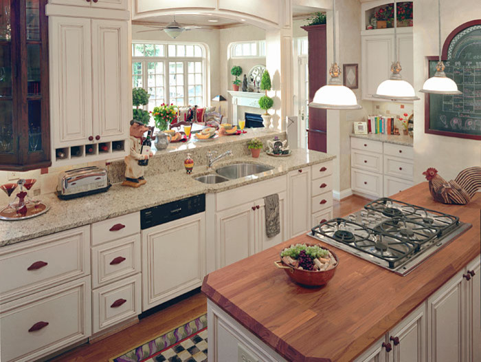 Large transitional medium tone wood floor kitchen photo in Cincinnati with white cabinets, wood countertops and an island