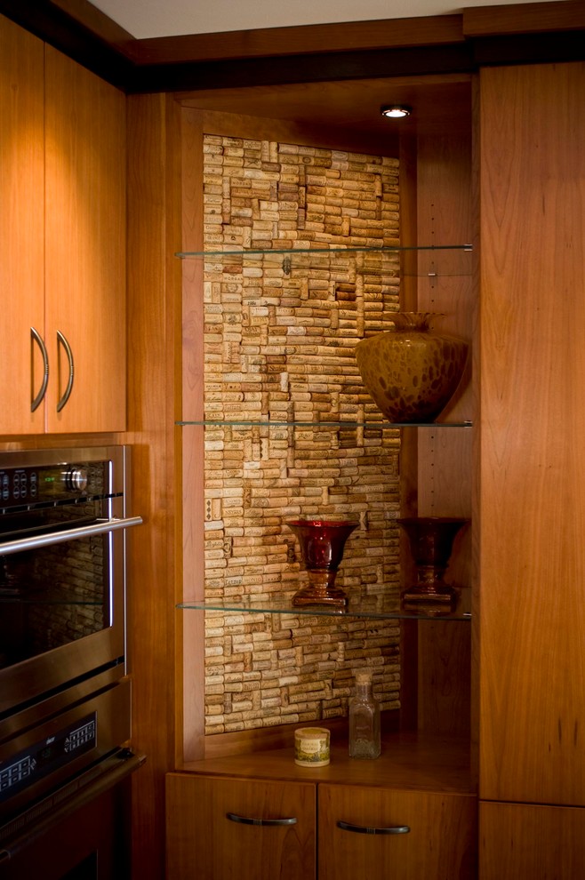 Imagen de cocina ecléctica con armarios con paneles lisos, puertas de armario de madera oscura y electrodomésticos de acero inoxidable