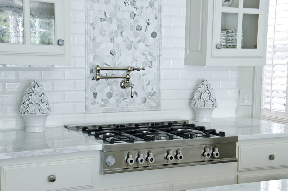 Immagine di una cucina design con ante a filo, ante bianche, top in marmo, paraspruzzi bianco, paraspruzzi con piastrelle diamantate e elettrodomestici in acciaio inossidabile