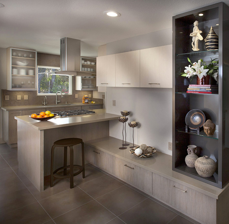 Eat-in kitchen - small contemporary galley porcelain tile eat-in kitchen idea in San Francisco with a drop-in sink, glass-front cabinets, light wood cabinets, beige backsplash, paneled appliances, a peninsula, quartzite countertops and glass tile backsplash