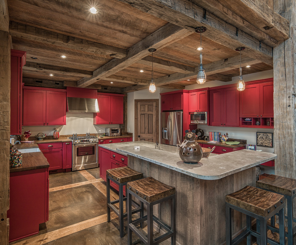 Open concept kitchen - mid-sized rustic u-shaped concrete floor open concept kitchen idea in Charlotte with a single-bowl sink, shaker cabinets, red cabinets, granite countertops, white backsplash, stainless steel appliances and an island