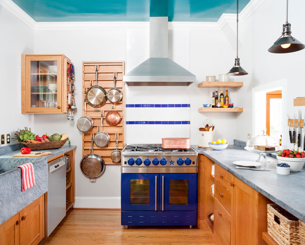 Inspiration for a transitional medium tone wood floor and orange floor kitchen remodel in DC Metro with a farmhouse sink, medium tone wood cabinets, concrete countertops, multicolored backsplash, colored appliances and no island
