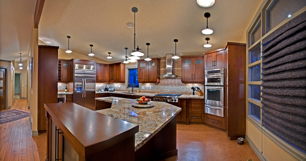 Eat-in kitchen - large transitional u-shaped cork floor eat-in kitchen idea in Calgary with an undermount sink, shaker cabinets, medium tone wood cabinets, granite countertops, an island, beige backsplash, porcelain backsplash and stainless steel appliances