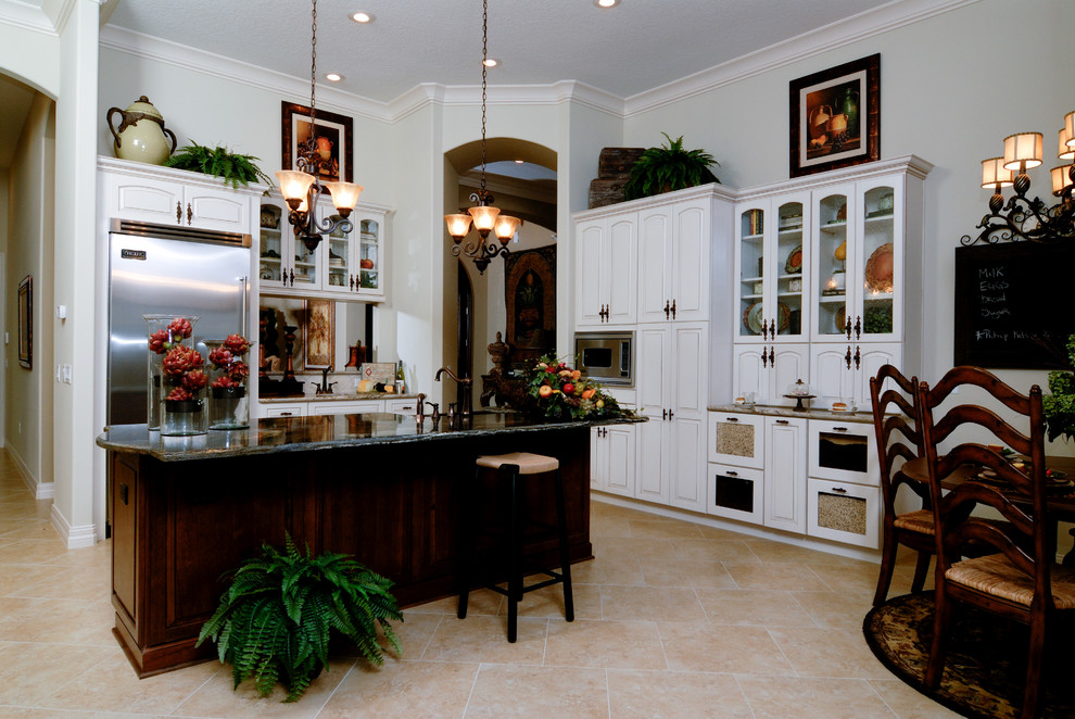 Inspiration for a timeless l-shaped dark wood floor and brown floor eat-in kitchen remodel in Orlando with an undermount sink, raised-panel cabinets, white cabinets, granite countertops, red backsplash, brick backsplash, stainless steel appliances and two islands